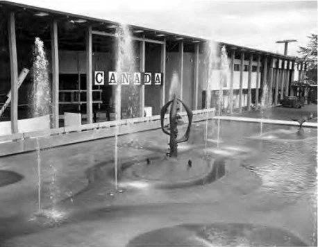 B&W photo of the fountain with the Canada Pavilion behind it