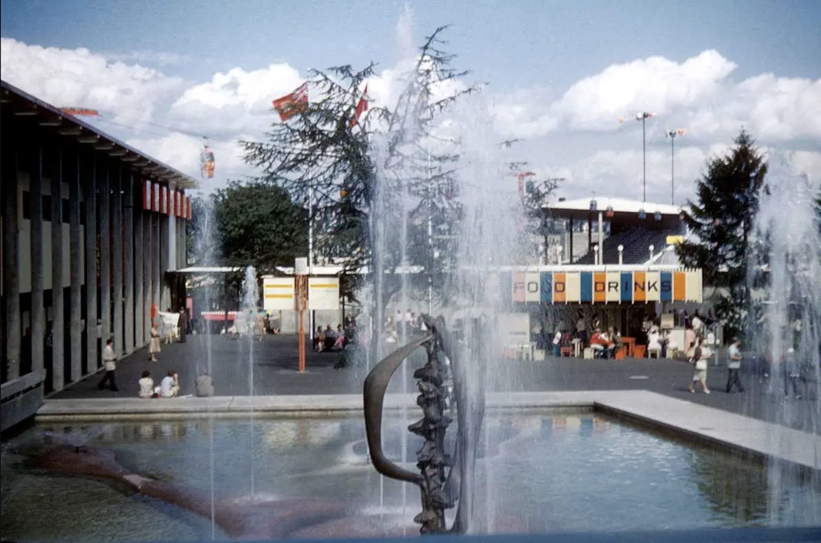 The fountain at the 1962 World's Fair, with fair pavilions and food stands in the background