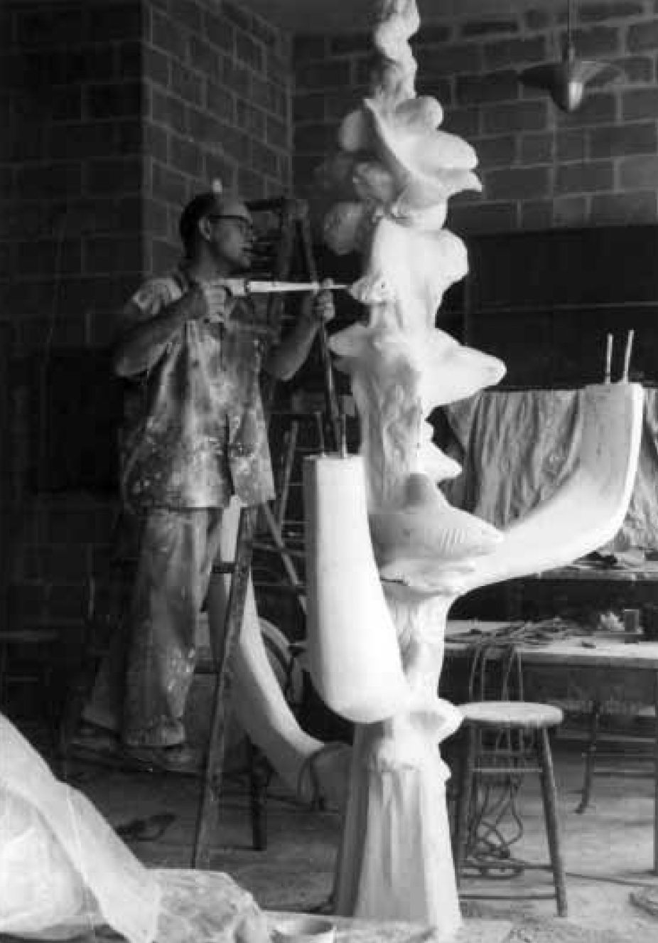 DuPen on a ladder working on the plaster model for the Fountain of Creation, c. 1960