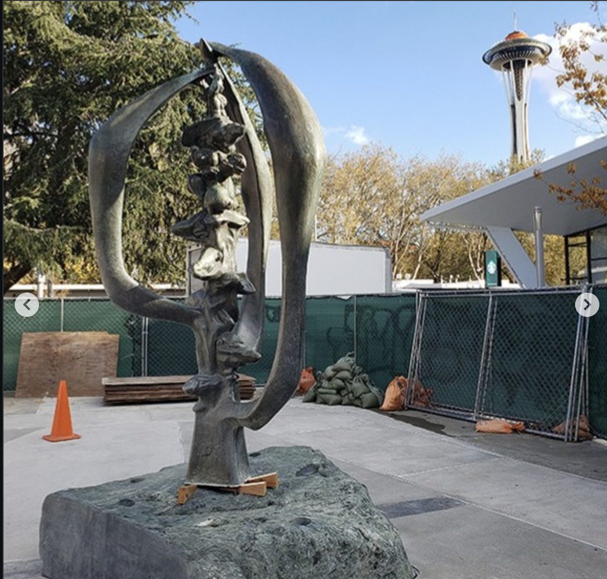 Evolution of Man on its new stone base with the Space Needle behind, construction in progress