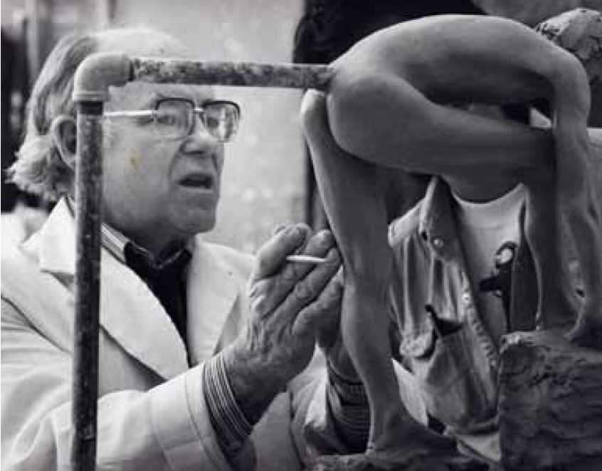 Close-up of DuPen examining a small figurative bronze