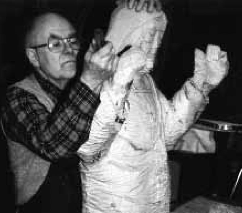 DuPen with hands on a plaster figure in progress