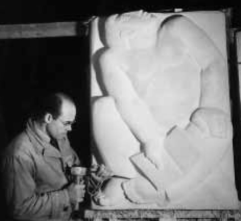 DuPen working on a large plaster relief of a seated figure