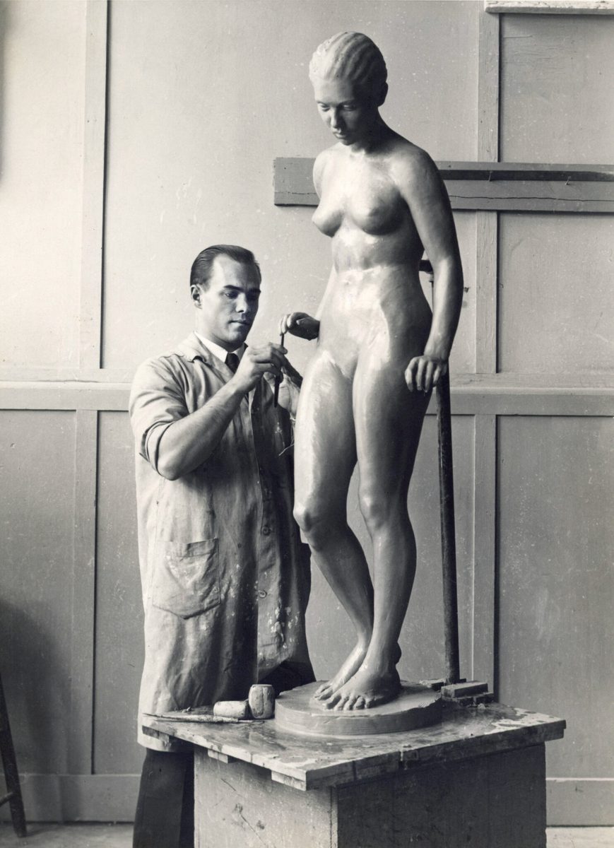 Young Everett DuPen at USC, working on a standing figure in clay, circa 1933